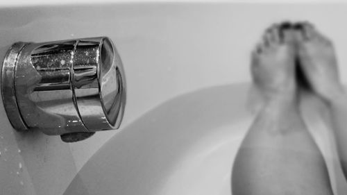 Reflection of woman on mirror in bathroom