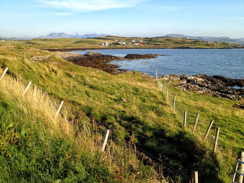 Scenic view of land and sea against sky