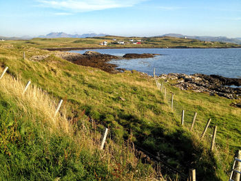 Scenic view of land and sea against sky