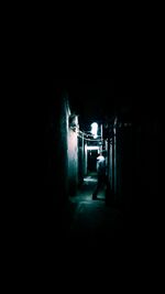 Illuminated alley amidst buildings in city at night