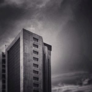 Low angle view of building against cloudy sky