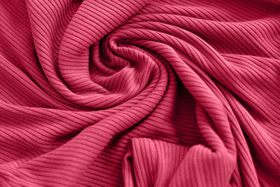 Viva magenta color of the year 2023, ribbed texture of cloth. fabric textile pattern.