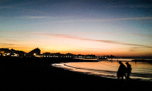 Silhouette of people at dusk