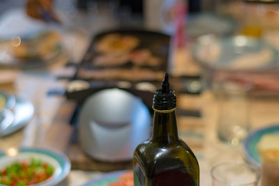 Close-up of olive bottle on table