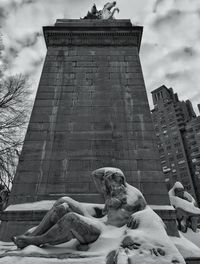Low angle view of eiffel tower against cloudy sky