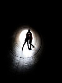 Silhouette of man in tunnel