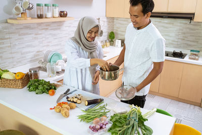 Woman standing by food at home