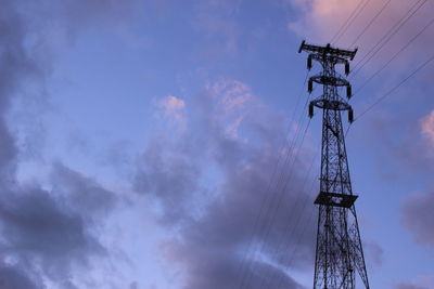 Low angle view of electricity pylon against sky