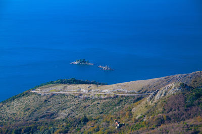 High angle view of ship sailing in sea against blue sky