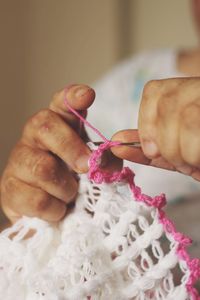 Cropped image of person knitting wool