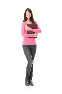 Portrait of a smiling young woman against white background