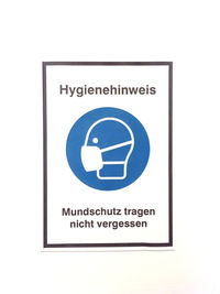 Close-up of warning sign on white background