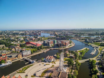 High angle view of river amidst buildings in city against clear sky