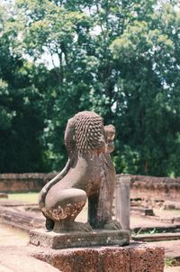 Close-up of lion statue against trees