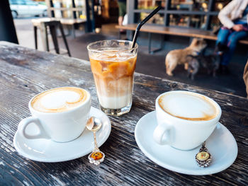 Close-up of coffee cups on table at sidewalk cafe