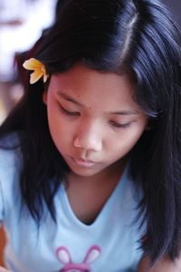 Close-up of thoughtful girl looking down