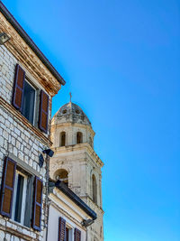 Low angle view of building against clear blue sky