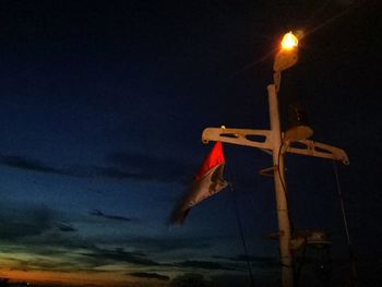 Low angle view of illuminated flag against sky at night