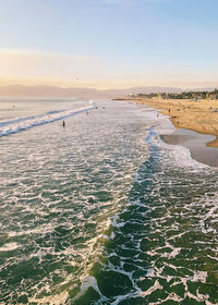 Scenic view of beach against sky during sunset