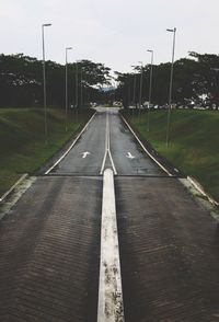 Road amidst trees against sky