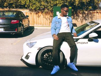Full length of man standing by car