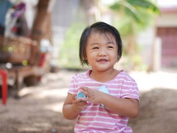 Portrait of cute girl holding outdoors