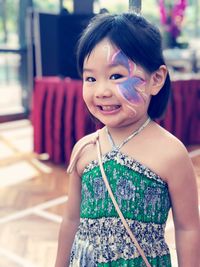 Portrait of smiling girl with face paint