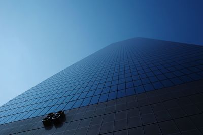 Low angle view of modern building against clear blue sky