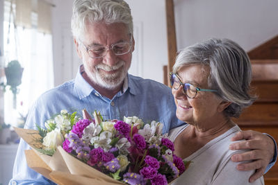 Side view of senior man holding bouquet