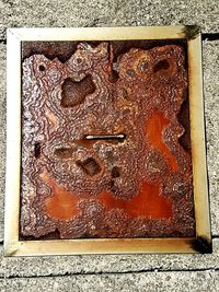 High angle view of rusty metal on wall