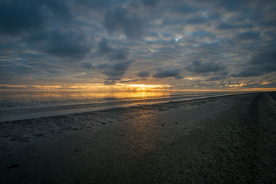 Scenic view of beach against sky during sunset