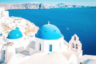 Panoramic view of sea and buildings against blue sky, santorini greece 