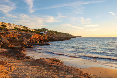 Waves wash onto the shore, cala tarida bay, ibiza, balearic islands, spain