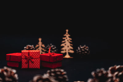 Close-up of christmas decorations on table against black background