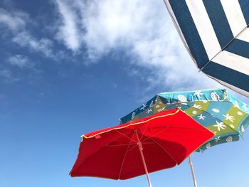 Low angle view of red umbrella against sky