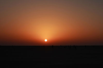 Scenic view of sea against orange sky