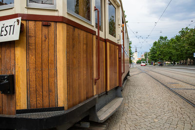 Street amidst railroad tracks in city against sky