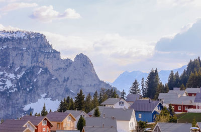 Colored houses on mountain against cloudy sky in flaine next to chamonix. 