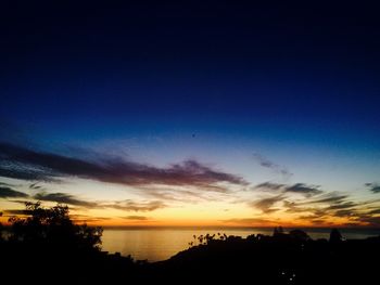 Scenic view of silhouette trees against sky during sunset