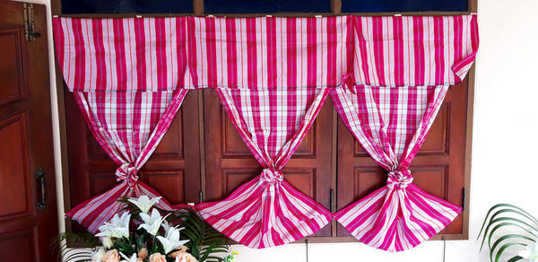 Close-up of pink flags hanging on clothesline