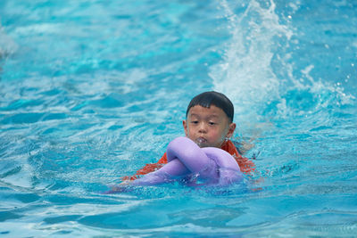 Portrait of cute girl swimming in pool