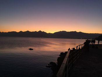 Scenic view of sea against clear sky during sunset
