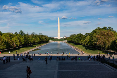 Group of people in park against sky