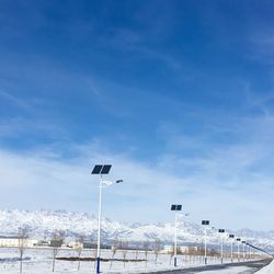 Solar panels on street lights against sky