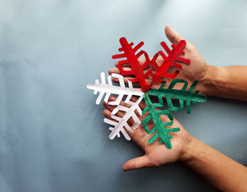 High angle view of person hand holding red paper