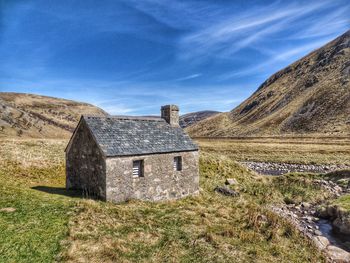 Built structure on field against sky