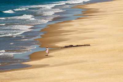 High angle view of woman walking on beach