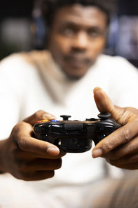 Midsection of woman holding remote control