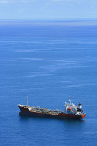 A ship crossing the blue sea of teluk bayur, west sumatra, indonesia.