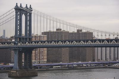 Side view of suspension brooklyn bridge with cables and gates on cloudy day in new york